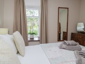 A bedroom with a bed and window at Rose Cottage in Broughton-In-Furness