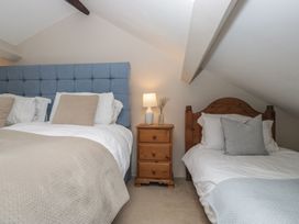 A bedroom with a bed and a nightstand at Rose Cottage in Broughton-In-Furness