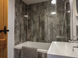 A bathroom with a bathtub and sink at Rose Cottage in Broughton-In-Furness