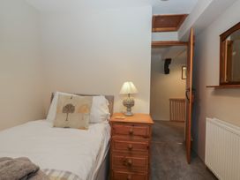 A bedroom with a single bed and nightstand at Rose Cottage in Broughton-In-Furness