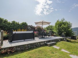 A garden with a hot tub and seating area at Rose Cottage in Broughton-In-Furness