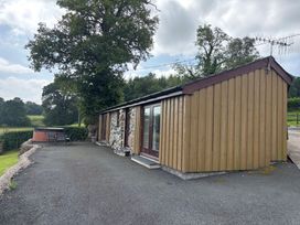 An outdoor area with a hot tub and seating at Bothi in Llanuwchllyn