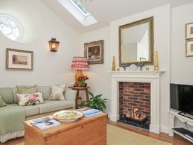 A living room with a sofa and decorative items at The Coach House at Pendower House Fowey