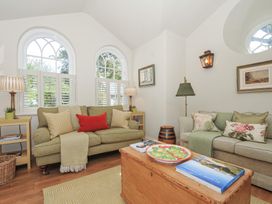 A living room with sofas and a coffee table at The Coach House at Pendower House Fowey