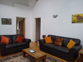 A living room with sofas and a coffee table at Dilly Dally Barn in Bradworthy near Bude
