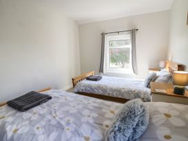A bedroom with two single beds and a window at Pengraig near Tregaron