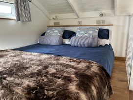A bedroom with a bed and pillows at Shepherds Cabin at Titterstone Clee Hill