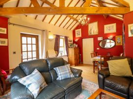 A living room with sofas and dining area at Gelli Glud in Eglwysbach