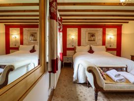 A bedroom with a bed and nightstand at Gelli Glud in Eglwysbach