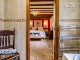 A bathroom with a view of a bedroom at Gelli Glud in Eglwysbach