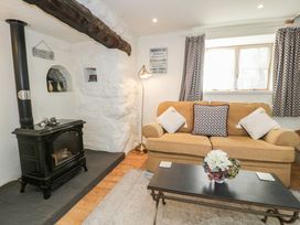 A living room with a sofa and coffee table at Happy Landing in Llanfair