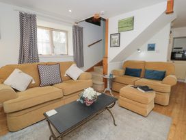 A living room with a sofa and coffee table at Happy Landing in Llanfair
