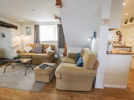 A living room with sofas and a coffee table at Happy Landing in Llanfair