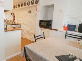 A kitchen with a table and chairs at Happy Landing in Llanfair