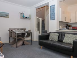 A living room with a dining table and sofa at Cottage 1 Newcourt in Torquay