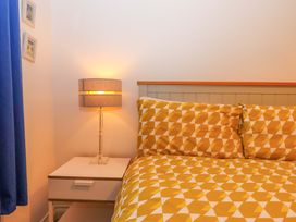 A bedroom with a bed and nightstand at Cottage 1 Newcourt in Torquay