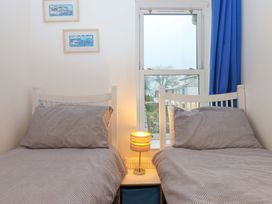 A bedroom with two beds and a lamp at Cottage 1 Newcourt in Torquay