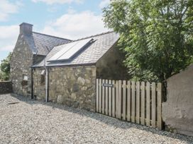 A house with solar panels and a gate at Cegin Foch in Chwilog