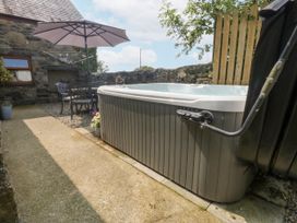An outdoor space featuring a hot tub and seating area at Cegin Foch in Chwilog