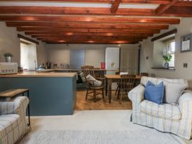 A kitchen with dining table and chairs at Cegin Foch in Chwilog