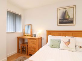 A bedroom with a bed and a dressing table at Cawsand in Tideford