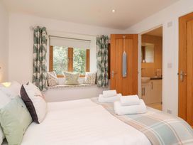 A bedroom with a bed and window seating at Cawsand, Tideford
