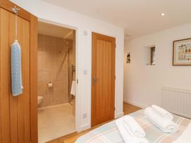 A bathroom with a shower and towels at Cawsand in Tideford