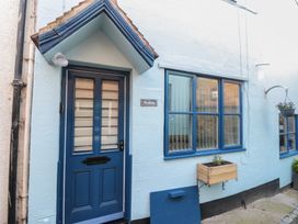 A blue door and window with planter at Bramla in Staithes
