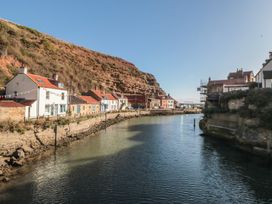 A river with houses along the banks at Bramla in Staithes