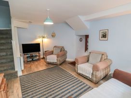 A living room with sofas and a television at Bramla, Staithes