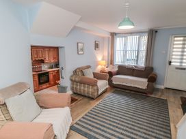 A living room with sofas and a kitchen area at Bramla in Staithes