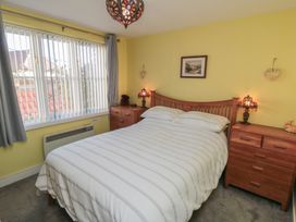 A bedroom with a bed and nightstands at Bramla in Staithes