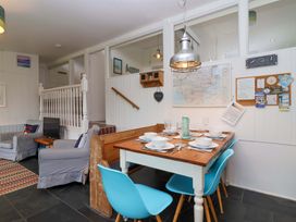 A dining area with a table and chairs at 2 Brook Cottages Hope Cove