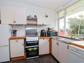 A kitchen with appliances and a sink at 2 Brook Cottages in Hope Cove