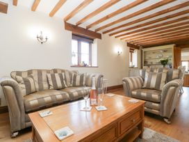 A living room with sofas and a coffee table at Penrhiwarwydd Barn in Pontywaun