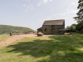 A house with a garden and a clothesline at Penrhiwarwydd Barn in Pontywaun
