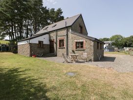 A house with a table and chairs outside at Penrhiwarwydd Barn in Pontywaun