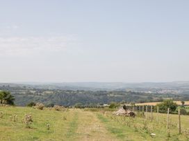 A field with a path and trees at Penrhiwarwydd Barn in Pontywaun