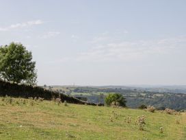 A landscape with hills and a stone wall at Penrhiwarwydd Barn Pontywaun