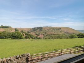 A view of hills and fields at Penrhiwarwydd Barn in Pontywaun