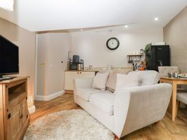 A living room with a sofa and television at Caner Bach Lodge in Blackmill
