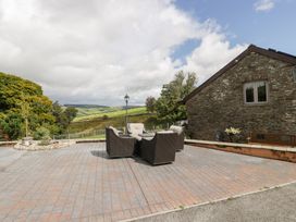An outdoor seating area with a couch at Caner Bach Lodge in Blackmill