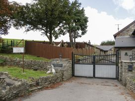 A gated entrance with a sign at Caner Bach Lodge in Blackmill