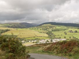 A landscape with fields and hills at Caner Bach Lodge in Blackmill