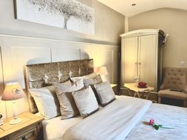 A bedroom with a bed and wardrobe at Caner Bach Lodge in Blackmill
