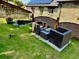 A garden area with seating and table at Caner Bach Lodge in Blackmill