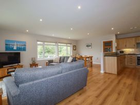 A living room with a sofa and television at The Meadow in Feock near Carnon Downs