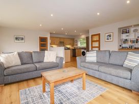 A living room with a sofa and table at The Meadow in Feock near Carnon Downs