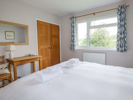 A bedroom with a bed and towels on it at The Meadow in Feock near Carnon Downs