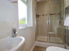 A bathroom with a shower, sink, and toilet at The Meadow in Feock near Carnon Downs
